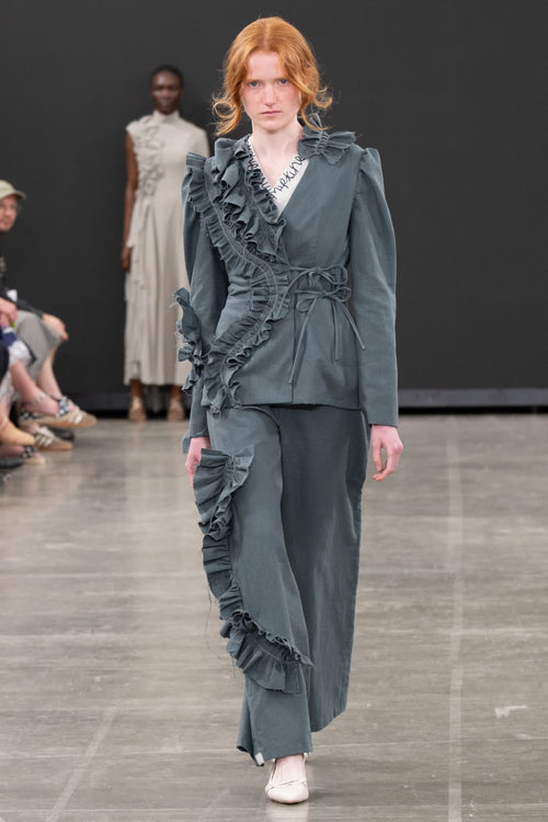 Look 03, slate tailored jacket with ruffled lapel and wide trousers. Photograph by Stone Clove.
