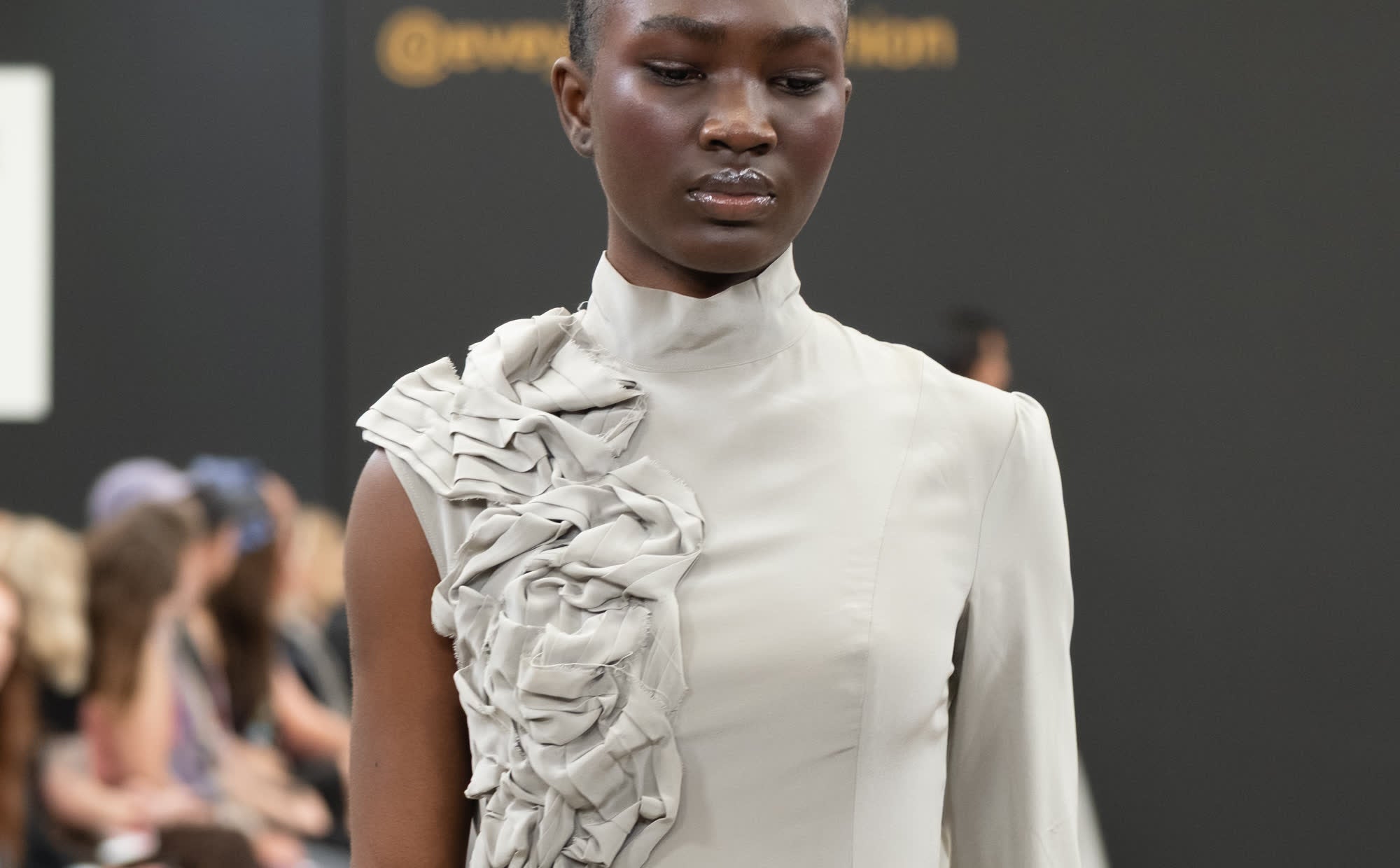 Look 01, the oyster column, photographed on the runway by Stone Clove.